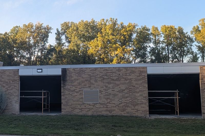 Garage door openings cut into the side of the building.