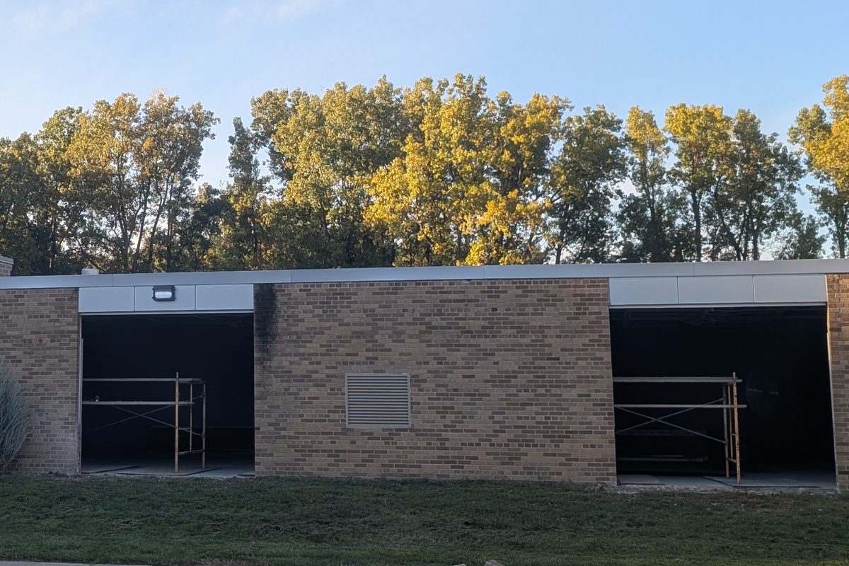 Two new garage door openings cut into the brick along the side of the building.